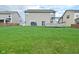 A spacious backyard with a well-maintained lawn, a wooden deck, and a small trampoline at 2336 Boneset Dr, Plainfield, IN 46168