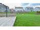 Lush backyard featuring a wooden deck, a metal pergola, and green grass at 2336 Boneset Dr, Plainfield, IN 46168