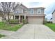 Charming two-story home with brick and beige siding, a covered porch, and an attached two-car garage at 2336 Boneset Dr, Plainfield, IN 46168