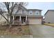 Two-story home with a brick and vinyl facade, attached two-car garage, and covered front porch at 2336 Boneset Dr, Plainfield, IN 46168