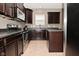 Well-equipped kitchen with dark cabinetry, stainless steel appliances, and stone countertops at 2336 Boneset Dr, Plainfield, IN 46168