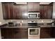 Modern kitchen featuring dark cabinets, stainless steel appliances, and ample counter space at 2336 Boneset Dr, Plainfield, IN 46168