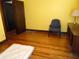 Bedroom features hardwood floors, yellow walls, and an open doorway at 2860 S Meridian St, Indianapolis, IN 46225