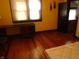 Bedroom with hardwood floors, bright natural light, and open doorframe at 2860 S Meridian St, Indianapolis, IN 46225