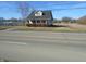 Charming single-story home featuring a brick foundation, front porch, and a dormer window at 2860 S Meridian St, Indianapolis, IN 46225