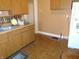 Traditional kitchen with wooden cabinets, linoleum flooring, and ample counter space at 2860 S Meridian St, Indianapolis, IN 46225