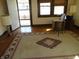 Inviting living room with a large area rug, neutral walls, natural light, and an open door at 2860 S Meridian St, Indianapolis, IN 46225