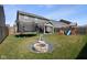 Expansive backyard with a fire pit, trampoline, playset, and covered patio perfect for outdoor activities at 2913 W Broderie Ln, Monrovia, IN 46157