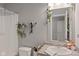 A functional bathroom showcases a sink, toilet, shower with curtain, and decorative greenery at 2913 W Broderie Ln, Monrovia, IN 46157