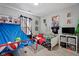A playful bedroom is set up with a mini basketball game and sports memorabilia in a bright, carpeted room at 2913 W Broderie Ln, Monrovia, IN 46157
