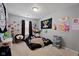 The cozy bedroom features plush carpeting, playful decorations, and a comfortable sleeping area with unique wall art at 2913 W Broderie Ln, Monrovia, IN 46157