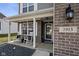 Inviting front porch with rocking chairs, brick accents, and decorative house number detail at 2913 W Broderie Ln, Monrovia, IN 46157