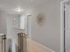 The upstairs hallway has neutral walls and carpet that features a decorative wooden flower and safety gate at 2913 W Broderie Ln, Monrovia, IN 46157