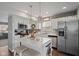 Modern kitchen with stainless steel appliances, white cabinetry, island, and pendant lighting at 2913 W Broderie Ln, Monrovia, IN 46157