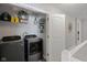 Convenient laundry room features modern washer and dryer, and built-in storage shelves for organization at 2913 W Broderie Ln, Monrovia, IN 46157