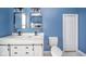 Updated bathroom featuring a double vanity, blue walls, and modern fixtures at 300 E North Main St, Summitville, IN 46070