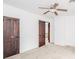 Bedroom features neutral carpet, ceiling fan, natural light, and an open doorway at 300 E North Main St, Summitville, IN 46070