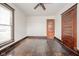 Bedroom featuring hardwood floors, one window, door and ceiling fan at 300 E North Main St, Summitville, IN 46070