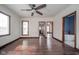 Large bedroom with hardwood floors, neutral walls, and multiple entryways at 300 E North Main St, Summitville, IN 46070