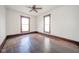 Bedroom featuring hardwood floors, and two windows at 300 E North Main St, Summitville, IN 46070