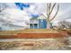 View of blue two-story home with porch, showing detailed architecture and the surrounding landscape at 300 E North Main St, Summitville, IN 46070