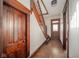Hallway with hardwood floors and a wooden staircase leading to the second floor at 300 E North Main St, Summitville, IN 46070