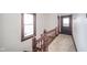 Hallway with wood banister and carpeted floor at 300 E North Main St, Summitville, IN 46070