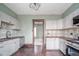 Updated kitchen with white cabinets, butcher block countertops, and unique backsplash at 300 E North Main St, Summitville, IN 46070