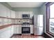 Updated kitchen features stainless steel appliances and modern finishes at 300 E North Main St, Summitville, IN 46070
