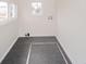 Utility room featuring neutral walls and grey carpeting with washer and dryer hook-ups at 300 E North Main St, Summitville, IN 46070