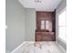 Room with white walls, marble-patterned tile floor and ornate built-in wooden storage at 300 E North Main St, Summitville, IN 46070