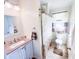 Bathroom featuring a vanity with a pink marble countertop, a toilet, and a shower at 327 Maxwell Rd, Indianapolis, IN 46217