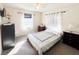 Cozy bedroom featuring neutral tones, plush carpet, and natural light from the window at 327 Maxwell Rd, Indianapolis, IN 46217