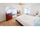 Bright bedroom with a ceiling fan, a bed, and blue and white curtains at 327 Maxwell Rd, Indianapolis, IN 46217