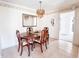 Formal dining room with a chandelier, wood table, chairs, and decorative mirrors at 327 Maxwell Rd, Indianapolis, IN 46217