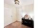 Hallway with neutral walls, carpet flooring, black storage cabinet, and two white doors at 327 Maxwell Rd, Indianapolis, IN 46217