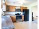 Well-lit kitchen with stainless steel appliances, tile floors, and wooden cabinetry at 327 Maxwell Rd, Indianapolis, IN 46217