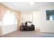 Cozy living room featuring an armchair, side table, and large window providing plenty of natural light at 327 Maxwell Rd, Indianapolis, IN 46217