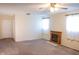 Spacious living room with a classic fireplace, ceiling fan, and carpet flooring at 327 Maxwell Rd, Indianapolis, IN 46217