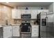 Kitchen with stainless steel appliances, white cabinetry, and granite countertops at 3278 Oceanline E Dr, Indianapolis, IN 46214
