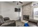 Comfortable living room features a stacked stone fireplace and flatscreen TV at 3278 Oceanline E Dr, Indianapolis, IN 46214