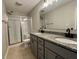 Well-lit bathroom features double sinks, granite countertops, and a glass-enclosed shower at 3408 Village Dr, Anderson, IN 46011