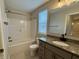 Bathroom featuring a granite countertop, a single sink, a tub and shower combination, and a toilet at 3408 Village Dr, Anderson, IN 46011