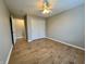 This bedroom features modern vinyl floors and ample natural light from the window at 3408 Village Dr, Anderson, IN 46011