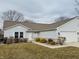 Charming single-story home with neutral siding, attached garage, and manicured landscaping at 3408 Village Dr, Anderson, IN 46011