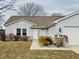 Well-maintained single-story home with attached garage and manicured landscaping at 3408 Village Dr, Anderson, IN 46011