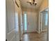 Well-lit hallway with hard surface floors and white doors at 3408 Village Dr, Anderson, IN 46011