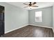 Bedroom with dark laminate floors, neutral colored walls and a ceiling fan at 3423 Shadow Bend Dr, Columbus, IN 47201