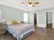 This bedroom has hardwood floors, a tray ceiling, a queen bed and leads to walk in closet and bathroom at 3423 Shadow Bend Dr, Columbus, IN 47201