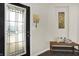 Inviting entryway with decorative glass door, wooden bench, and neutral decor, setting a welcoming tone at 3423 Shadow Bend Dr, Columbus, IN 47201
